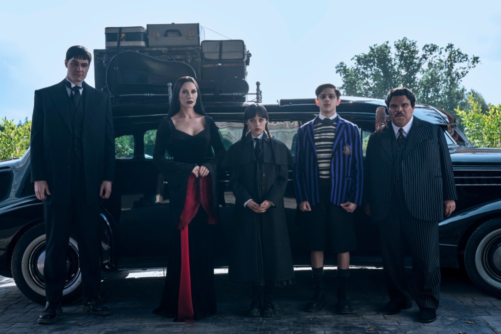 Wednesday. (L to R) Joonas Suotamo as Lurch, Catherine Zeta-Jones as Morticia Addams, Jenna Ortega as Wednesday, Isaac Ordonez aș Pugsley Addams, Thing, Luis Guzmán as Gomez Addams in episode 201 of Wednesday. Cr. Helen Sloan/Netflix © 2025
